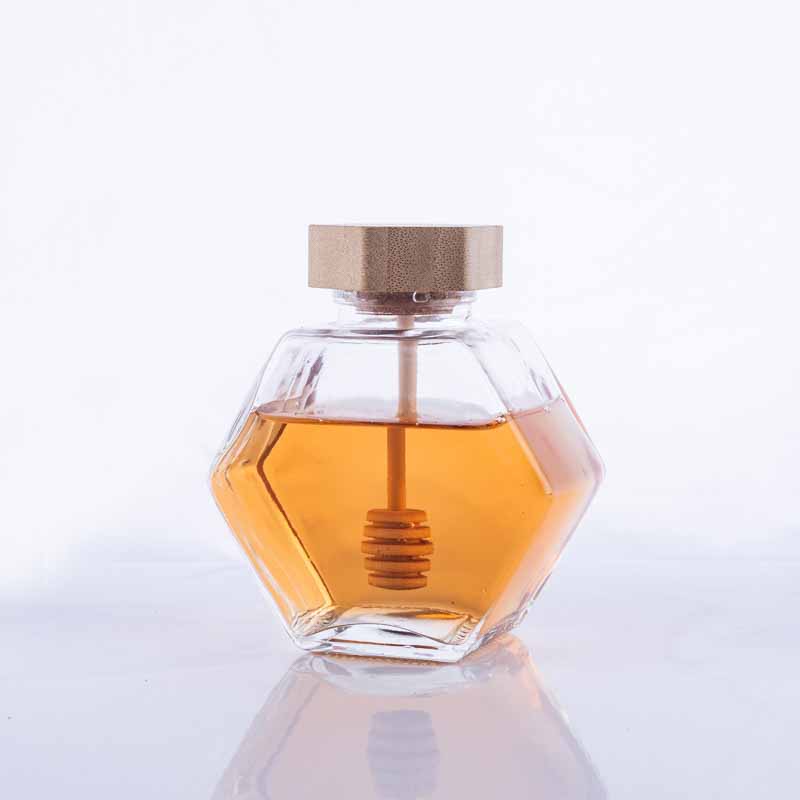 Transparent hexagonal glass honey jars with wood lid