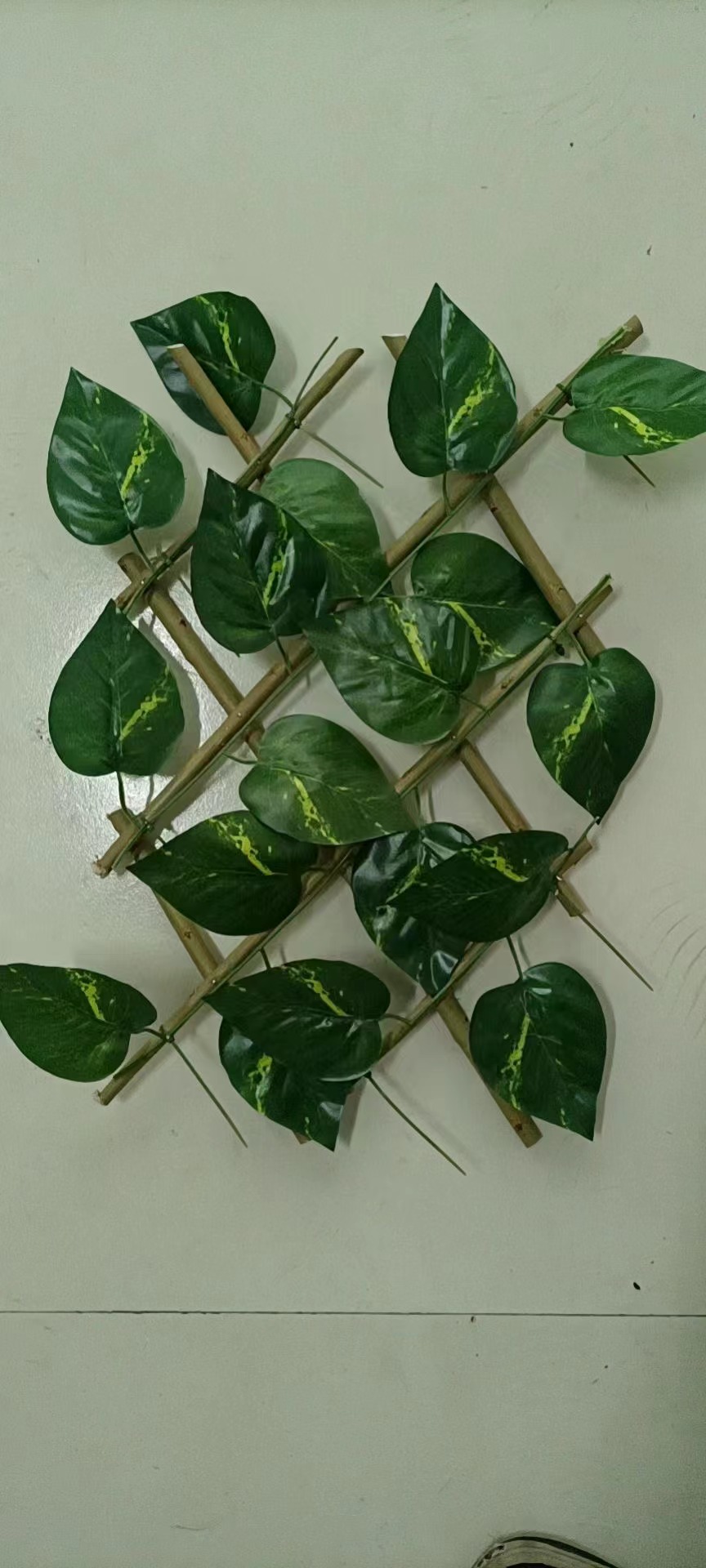 willow trellis with artificial leaves and artificial flowers