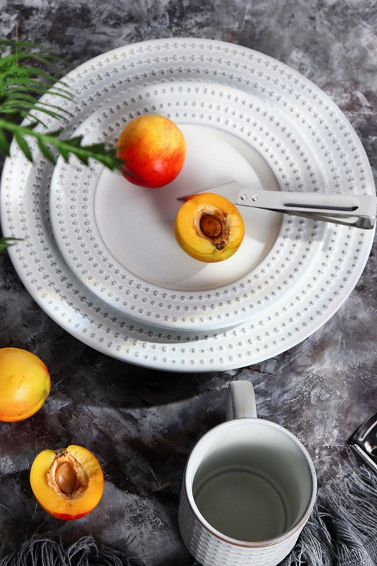 Reactive glaze dinnerware in embossed rimmed shape-white