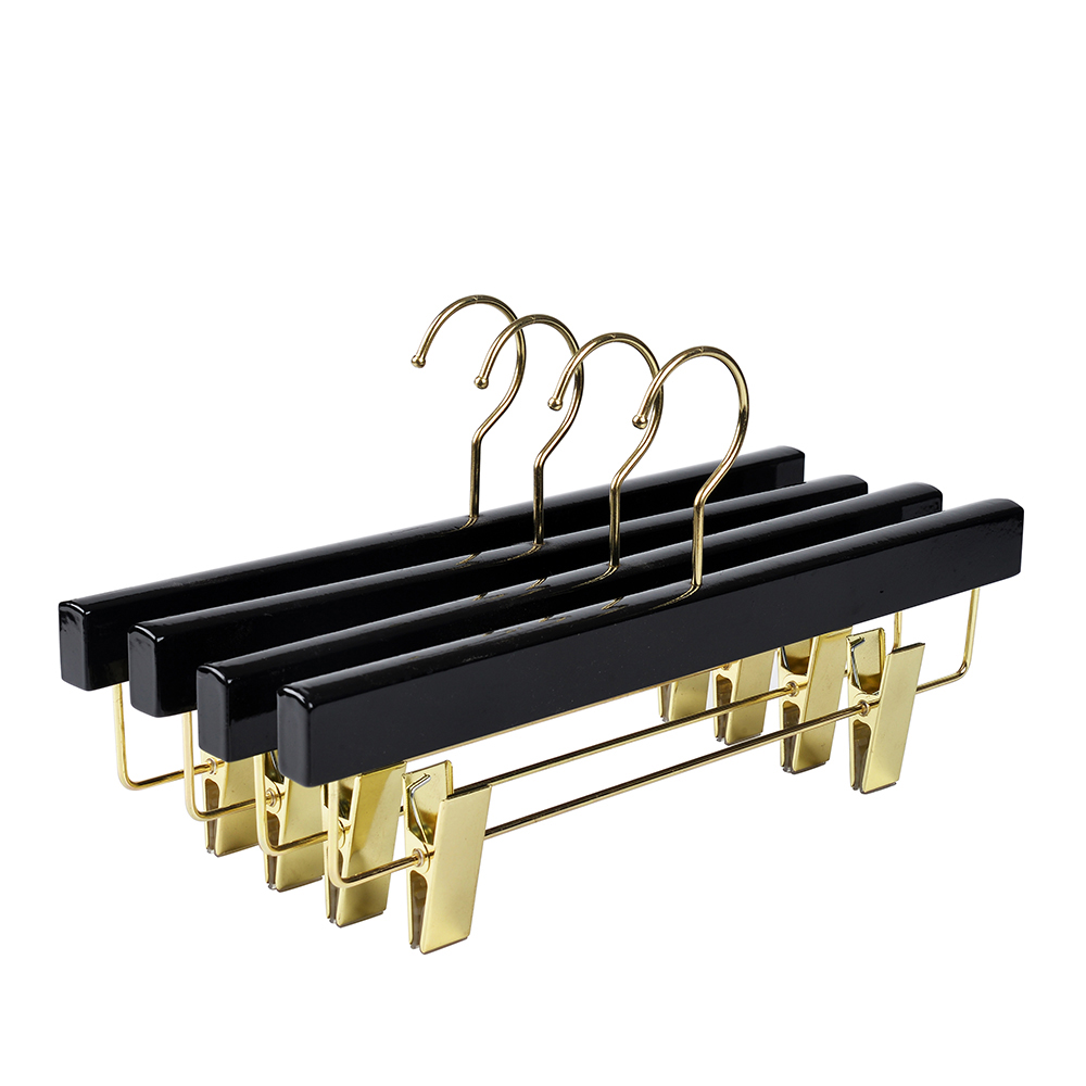 Black wooden pants hanger with gold clips for fashion shop