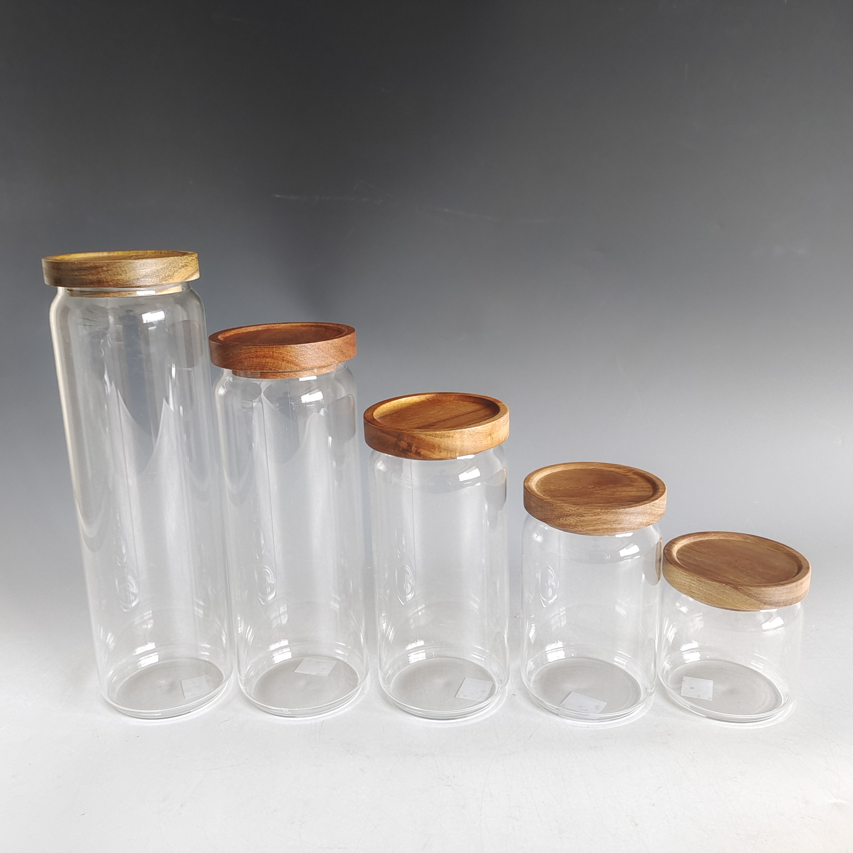 Glass container with acacia lid
