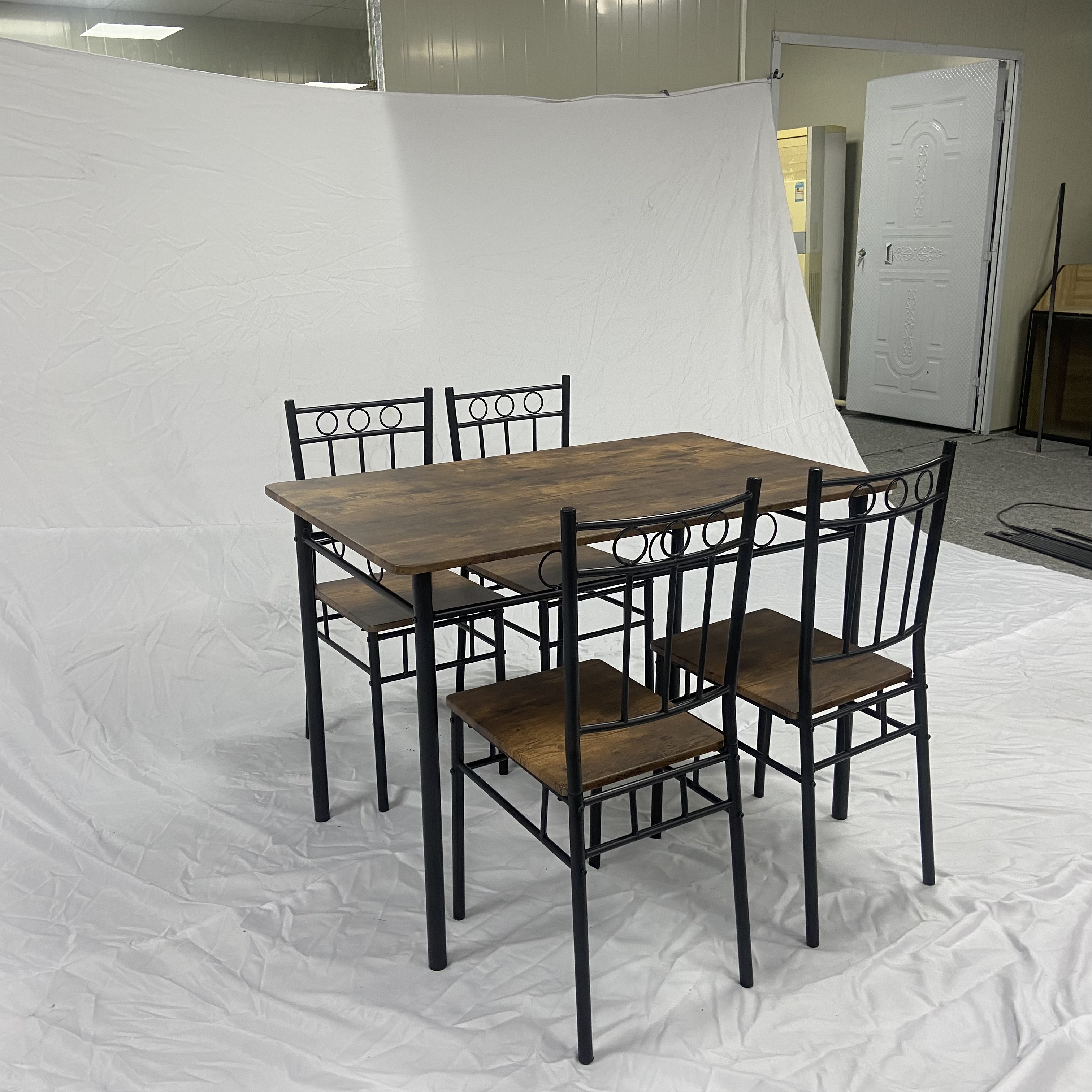 A dining table and four matching chairs