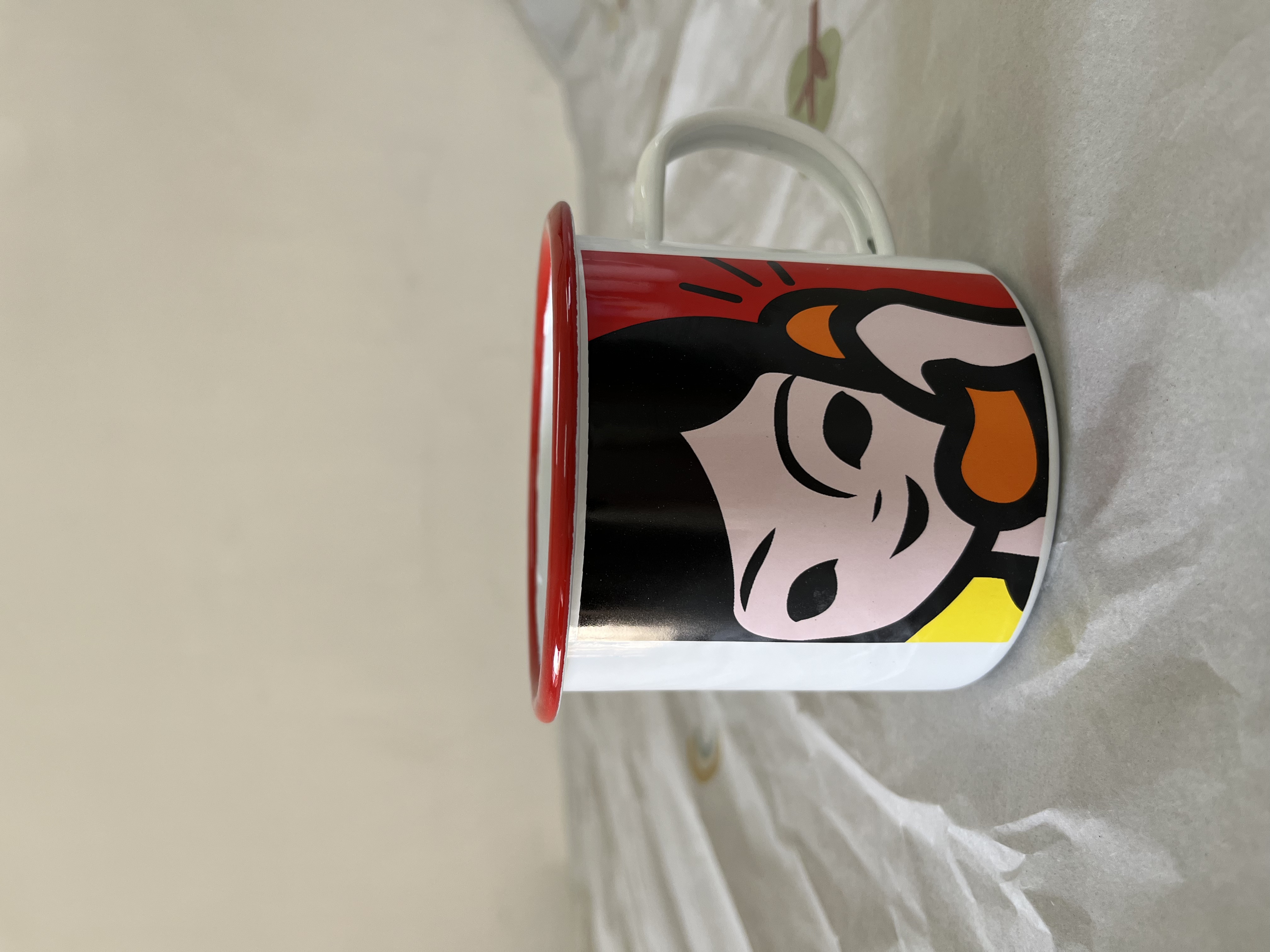 Enamel mug with white inside and floral outside