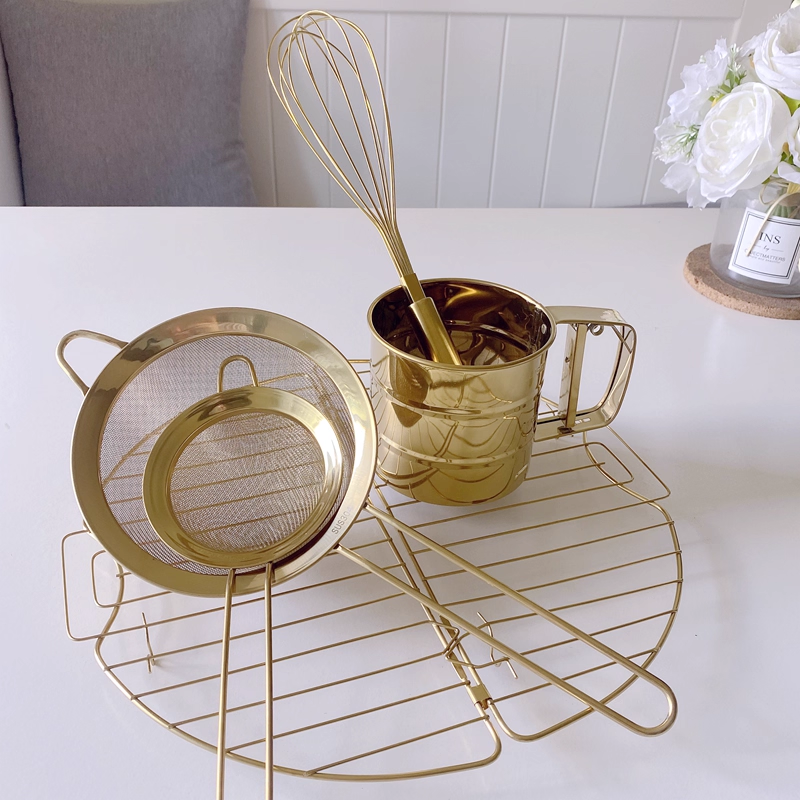 INS Nordic-style golden kitchen baking tools: whisk, flour sieve, cupcake cooling rack, gloves