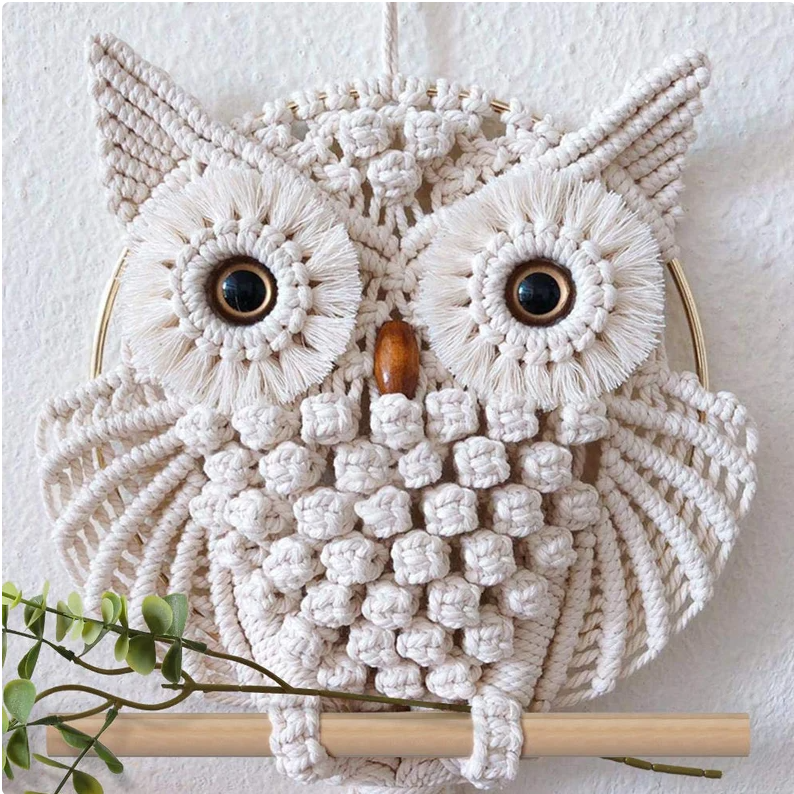 Hand-woven owl pendant with lace on the wall