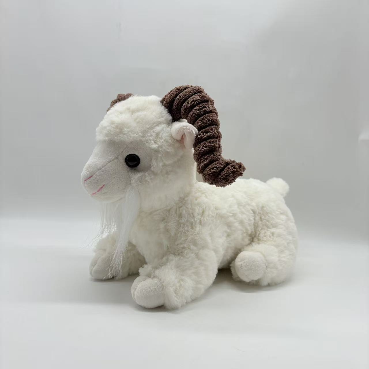 Plush toy, lying goat, black and white
