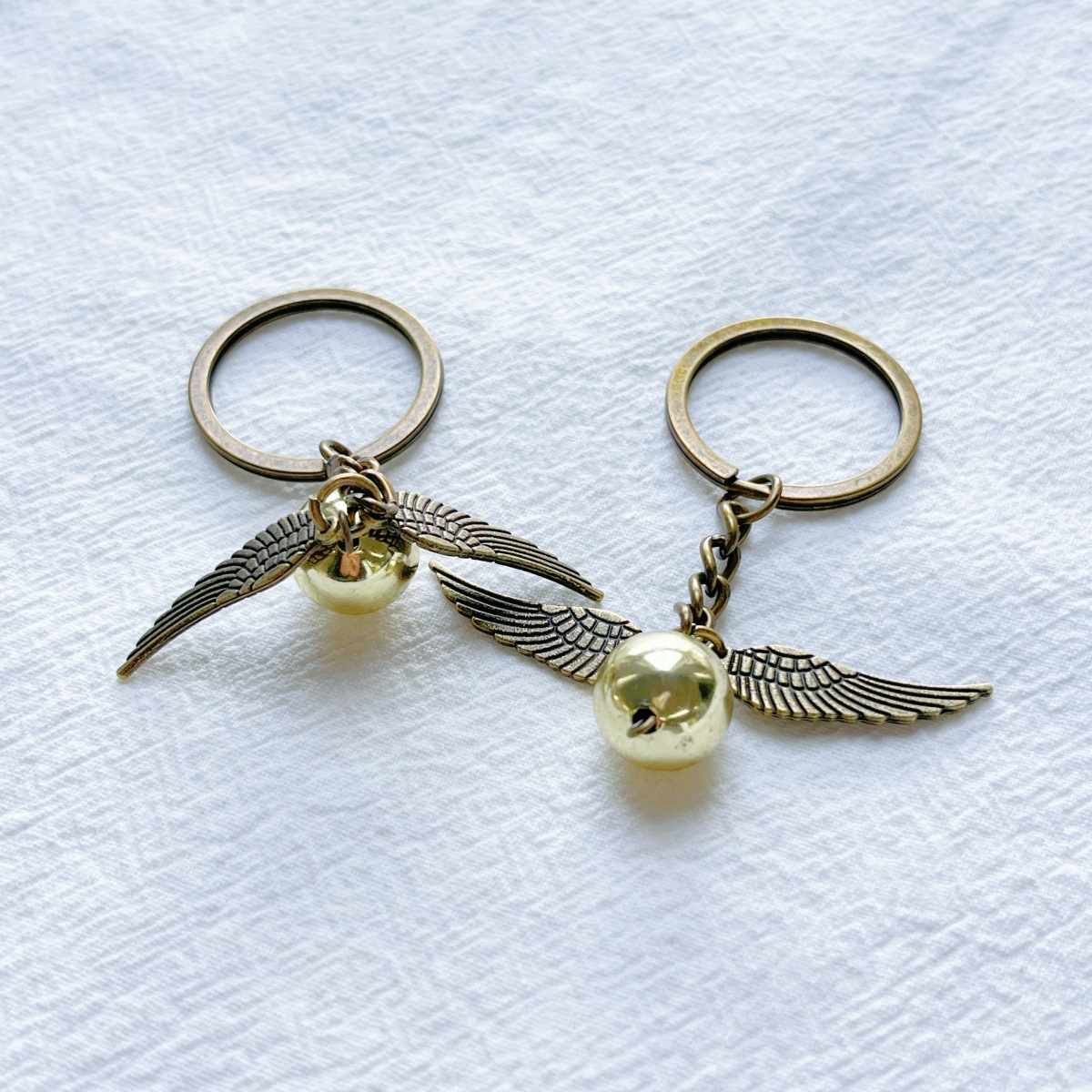 Generic Harry Potter Keychain with Golden Snitter & Deathly Hallows Charm Movie Jewelry