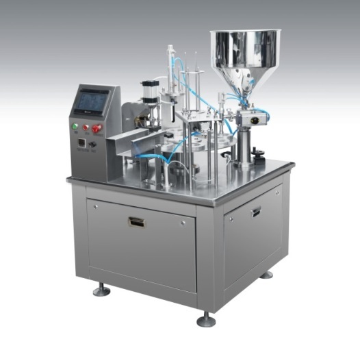 Rotary cup filling and sealing machine